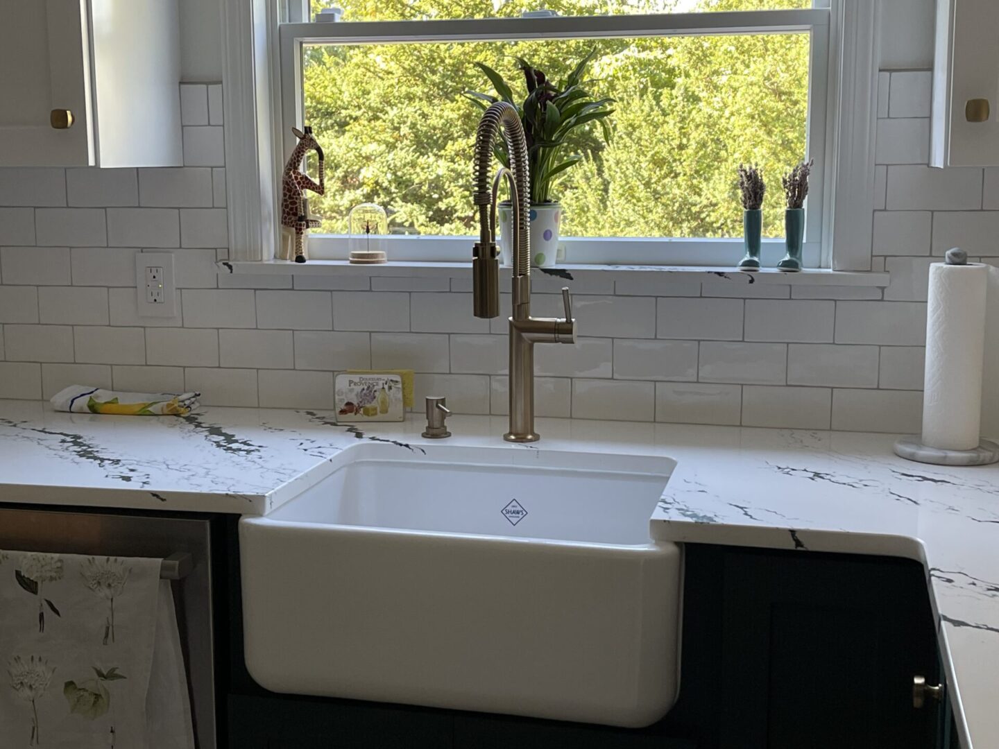 A kitchen sink with a window in the background.