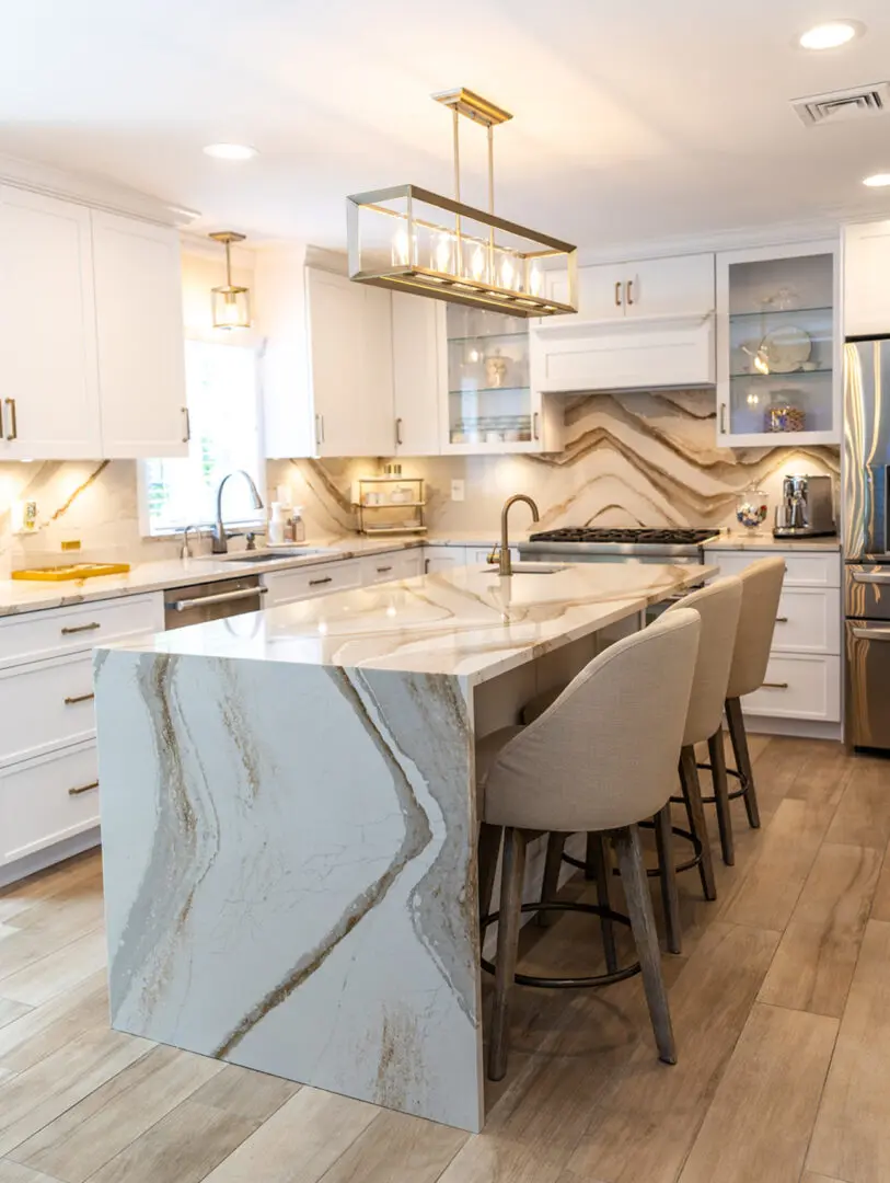 A kitchen with white cabinets and marble counter tops.