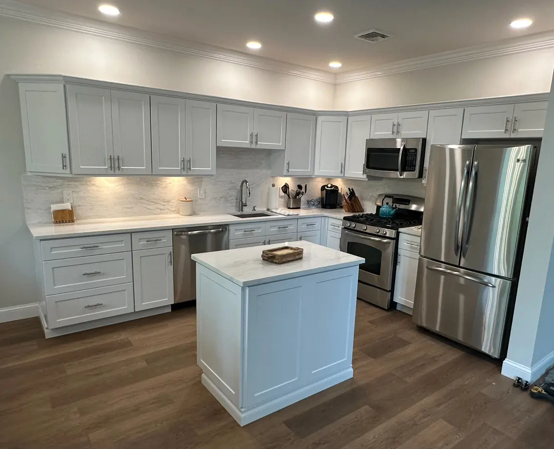 A kitchen with white cabinets and stainless steel appliances.